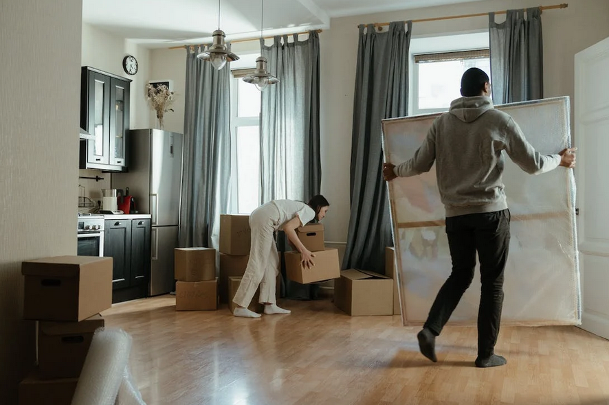 Two people moving into a new home